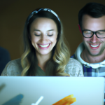 Happy people with big smiles using computers